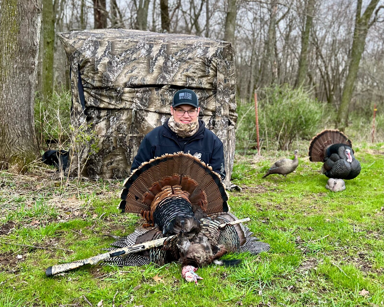 Tom turkey harvest in front of a ground blind with decoys